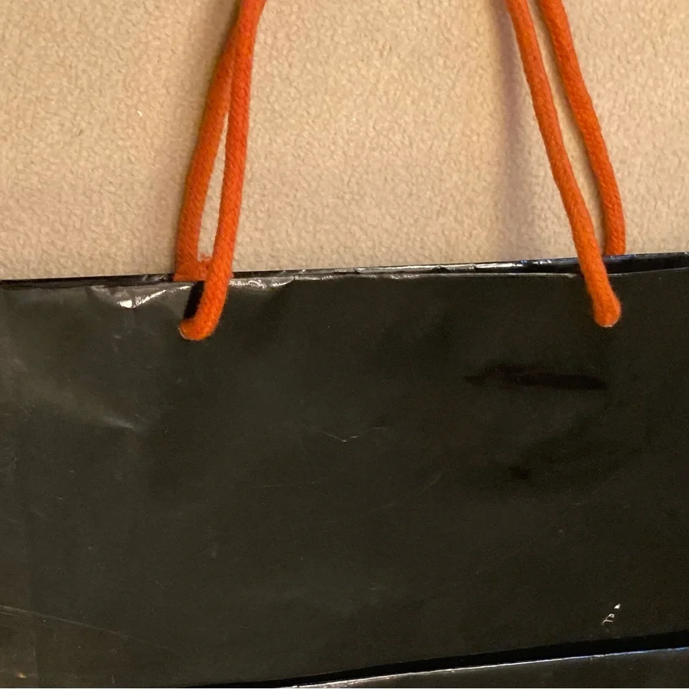 Guy Laroche Paris,black gloss glazed paper branded shopping tote,orange handles